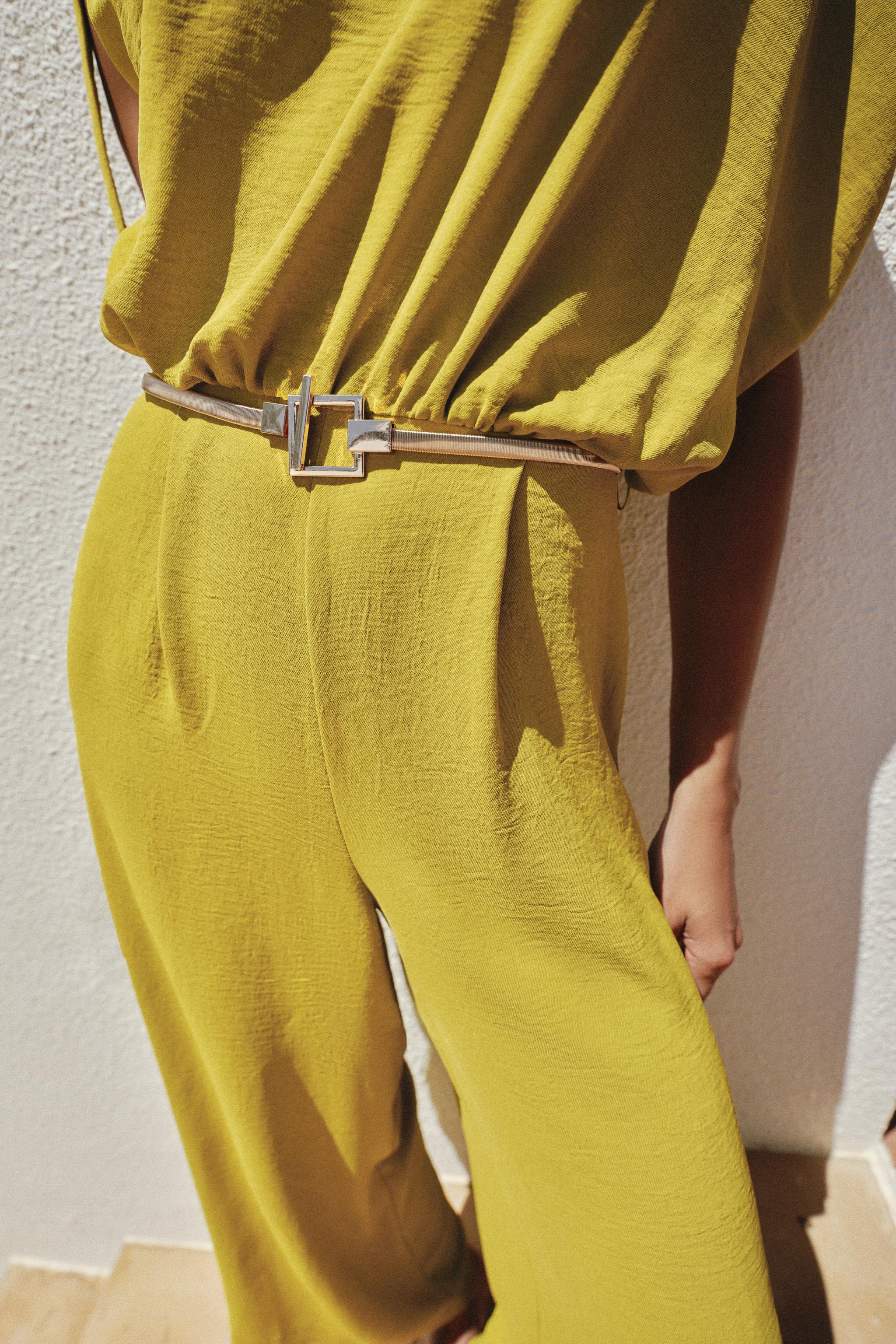ASYMMETRIC SLEEVE BELTED JUMPSUIT