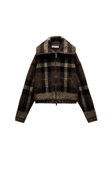 Front view of brown plaid jacket with zipper and high collar.