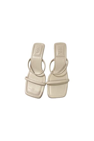 Beige block heel sandals with thin straps and "ZARA" logo on the insole, viewed from above on a white background.