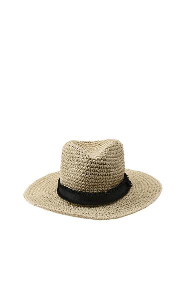 Front view of beige straw hat with black ribbon.