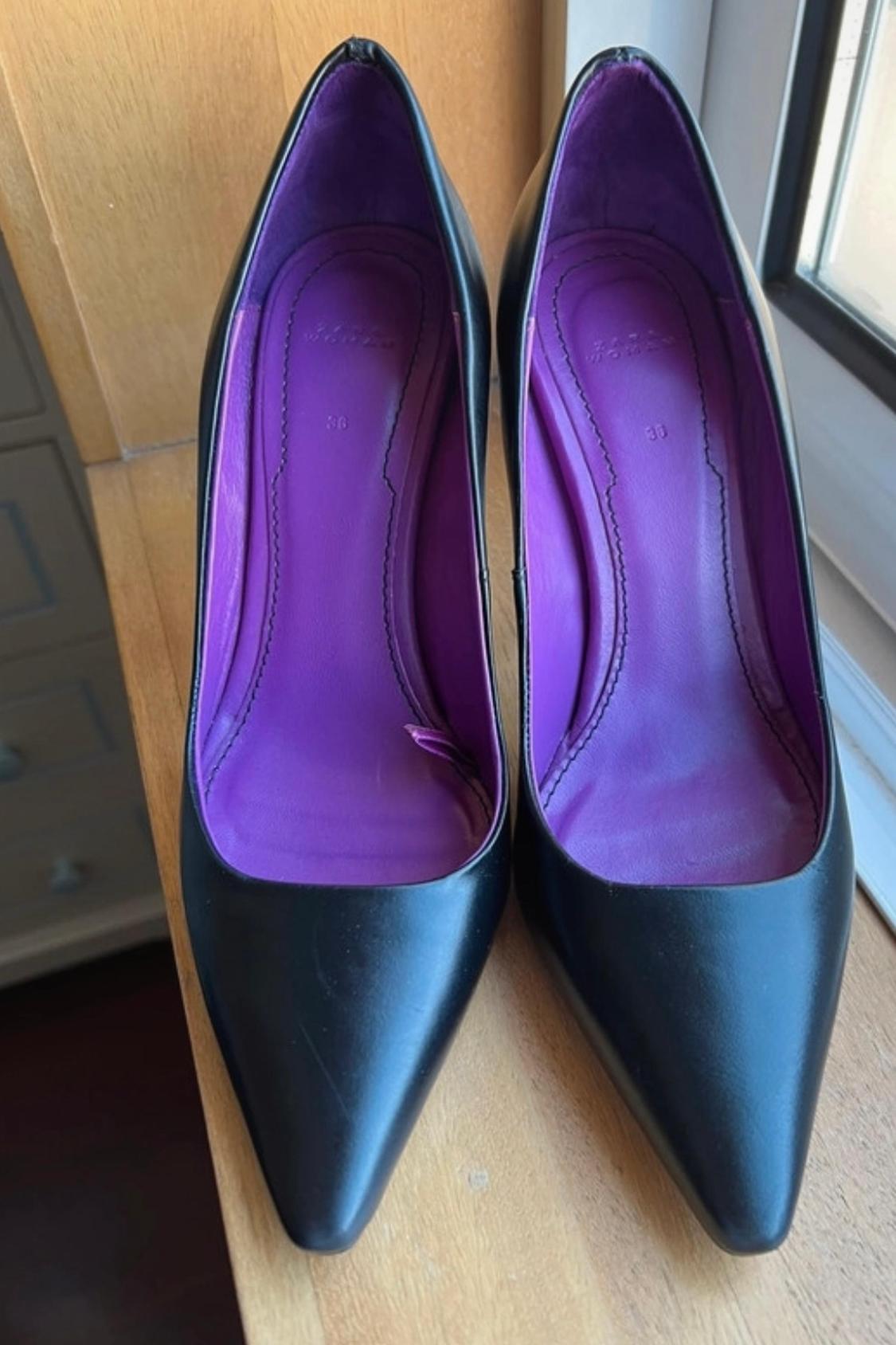 Front view of black high heels with purple lining