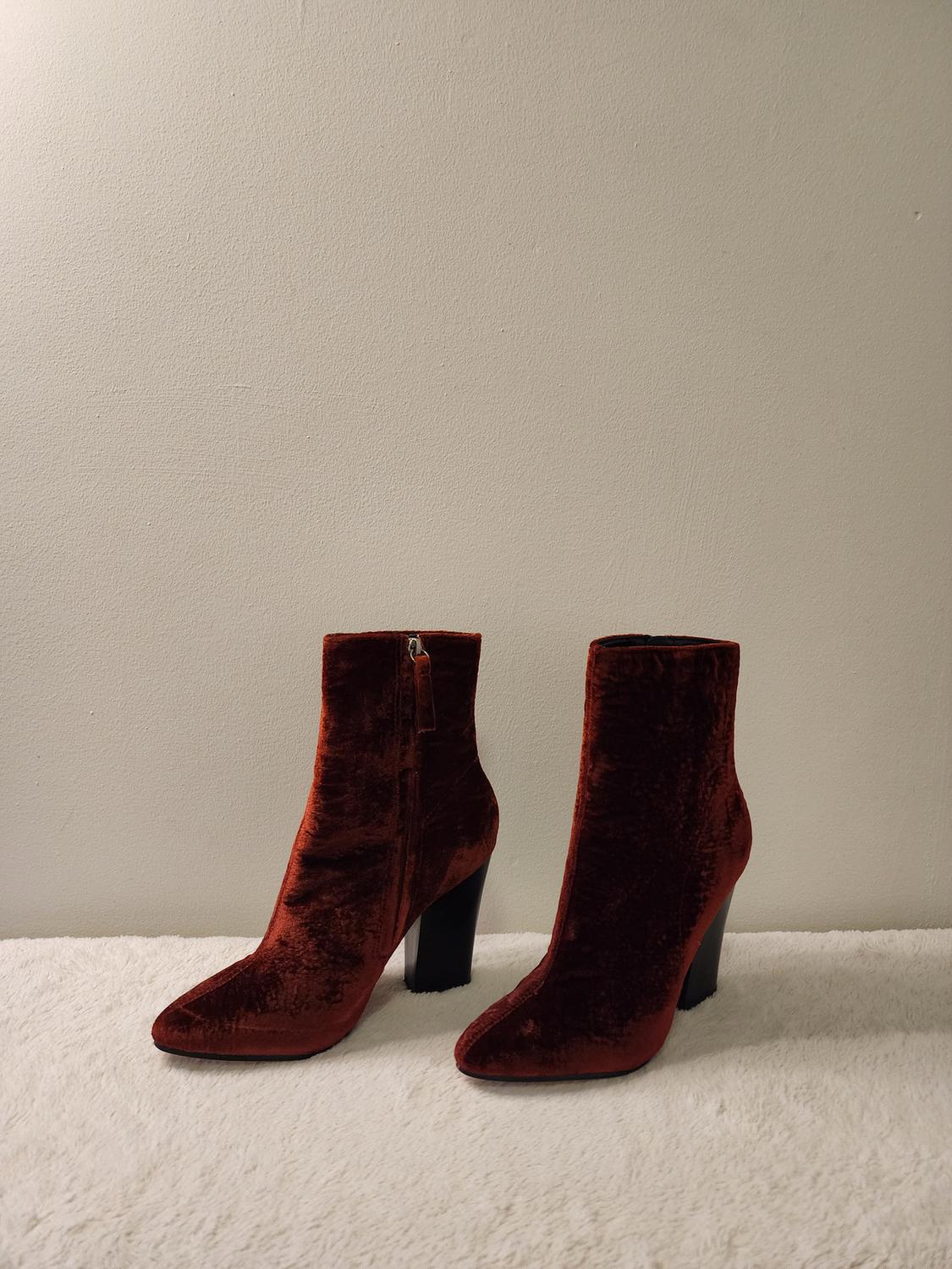 Front view of dark red velvet ankle boots with high heel and side zipper.