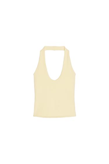 Front view of a cream-coloured, sleeveless top with a plunging neckline.