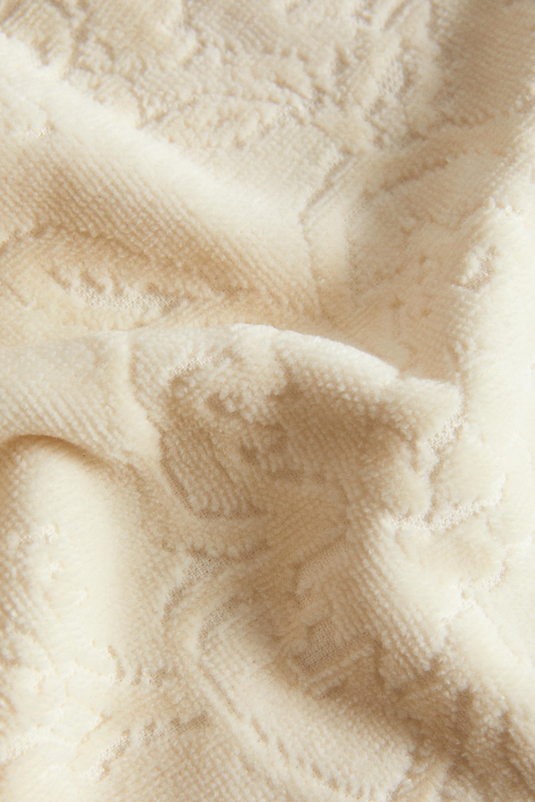 SERVIETTE DE BAIN POMPONS JACQUARD