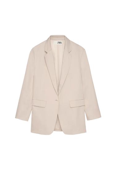 Front view of a beige blazer with lapels and front flap pockets.