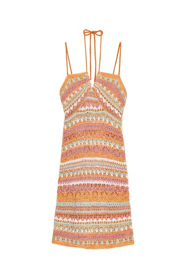 Front view of a multicoloured knitted mini dress with a V-neck and thin straps tied at the neck.
