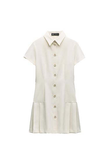 Short ecru dress with short sleeves and a shirt collar. Front button fastening and pleated hem. Label with ZARA text.