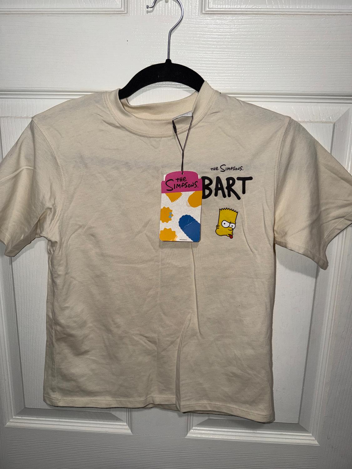 Beige T-shirt with Bart Simpson print and "The Simpsons BART" text. Colourful design hang tag.