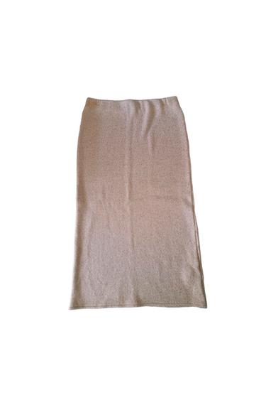 Light beige long skirt on a white background, with a soft texture and a straight drape.