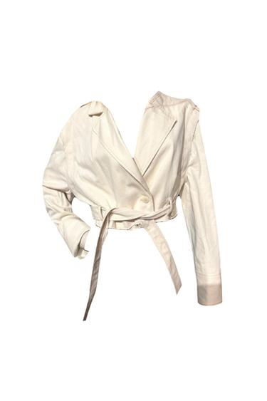 Front view of a short white jacket with lapels and a belt.