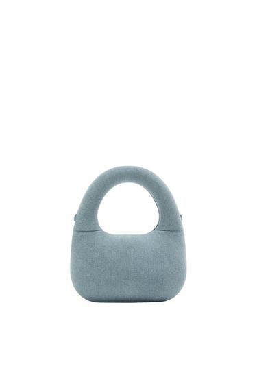 Light blue handbag with a curved design and rounded handle, on a minimalist white background.