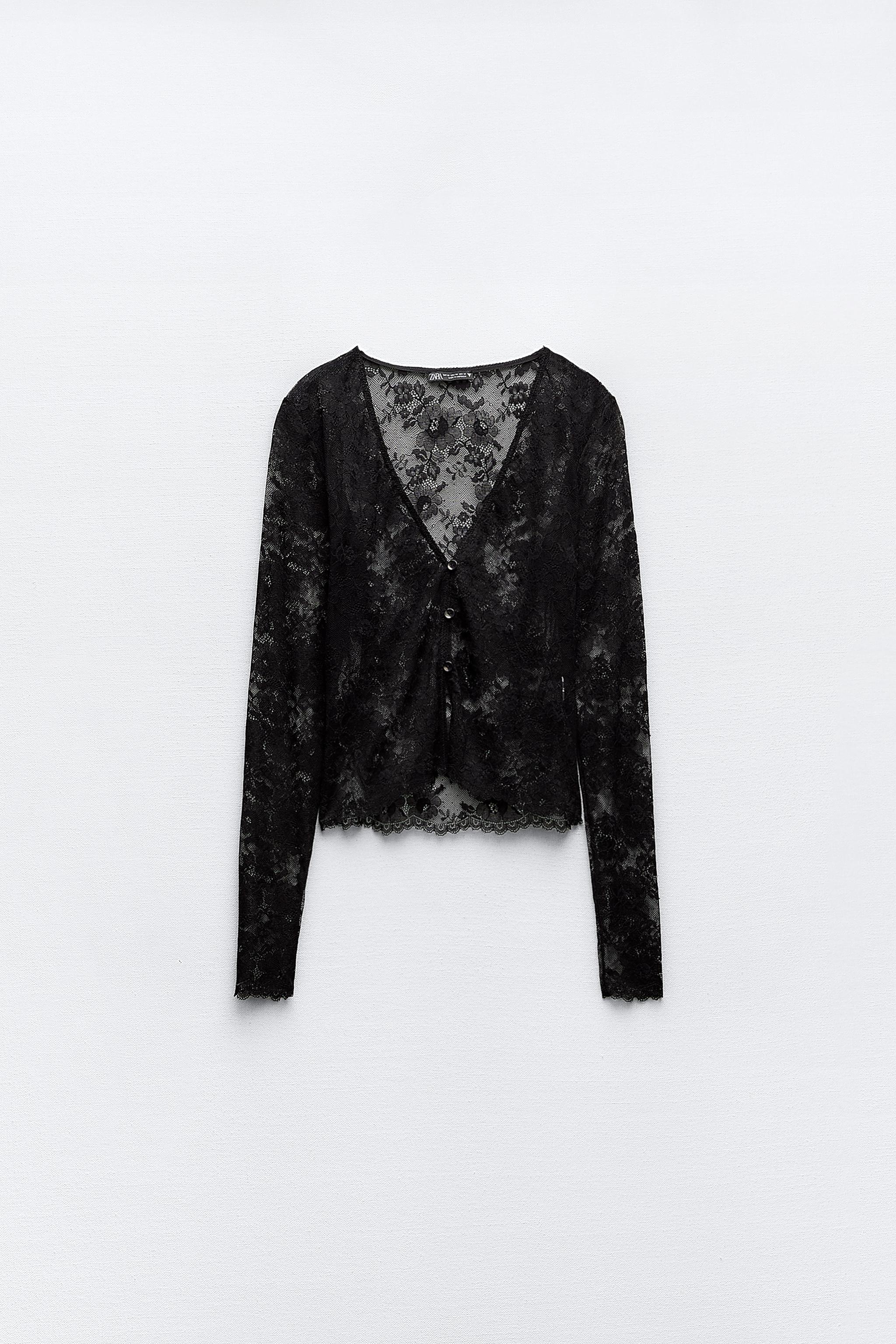 English) A black lace body with leather leggings and sequin jacket