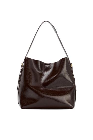 Large shoulder bag in a shiny dark brown tone with a crinkled texture and a single handle, photographed against a white background.