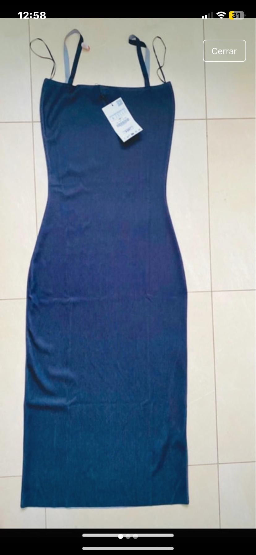 Front view of blue spaghetti strap dress with visible label.
