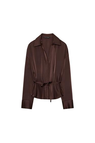Front view of a chocolate brown blouse with a shirt collar, long sleeves, and a thin belt. Concealed button-front fastening.