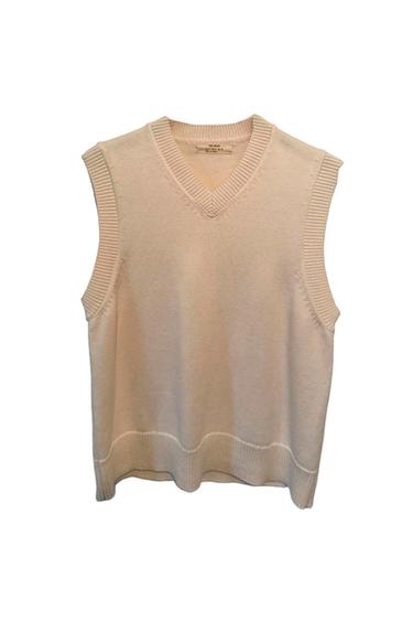 Beige sleeveless V-neck knitted waistcoat. Visible internal label with size and brand details.