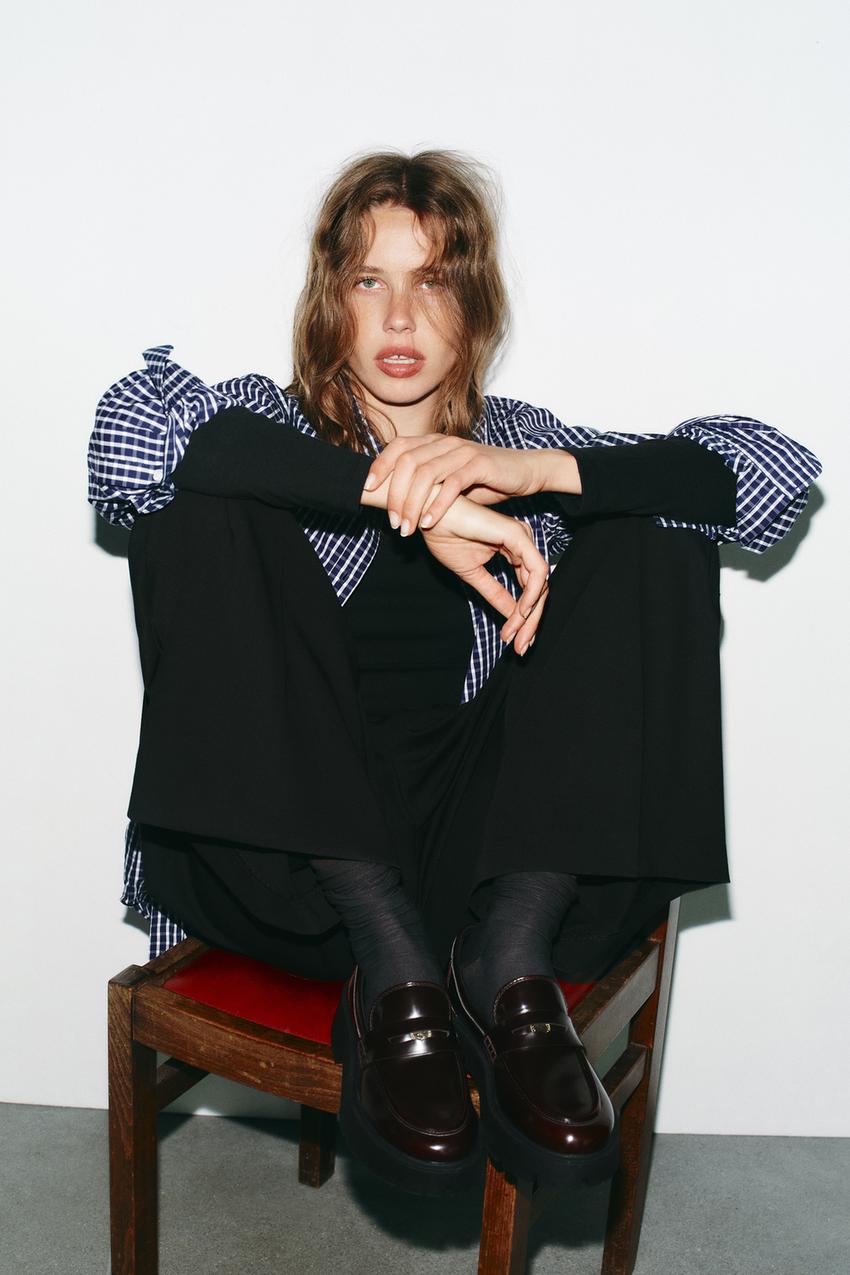 Burgundy loafer set with lug platform sole, black pants, and blue and white plaid shirt.