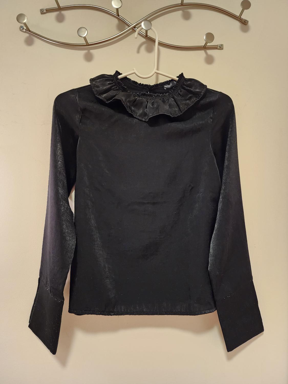 Front view of black blouse with gathered neckline and long sleeves