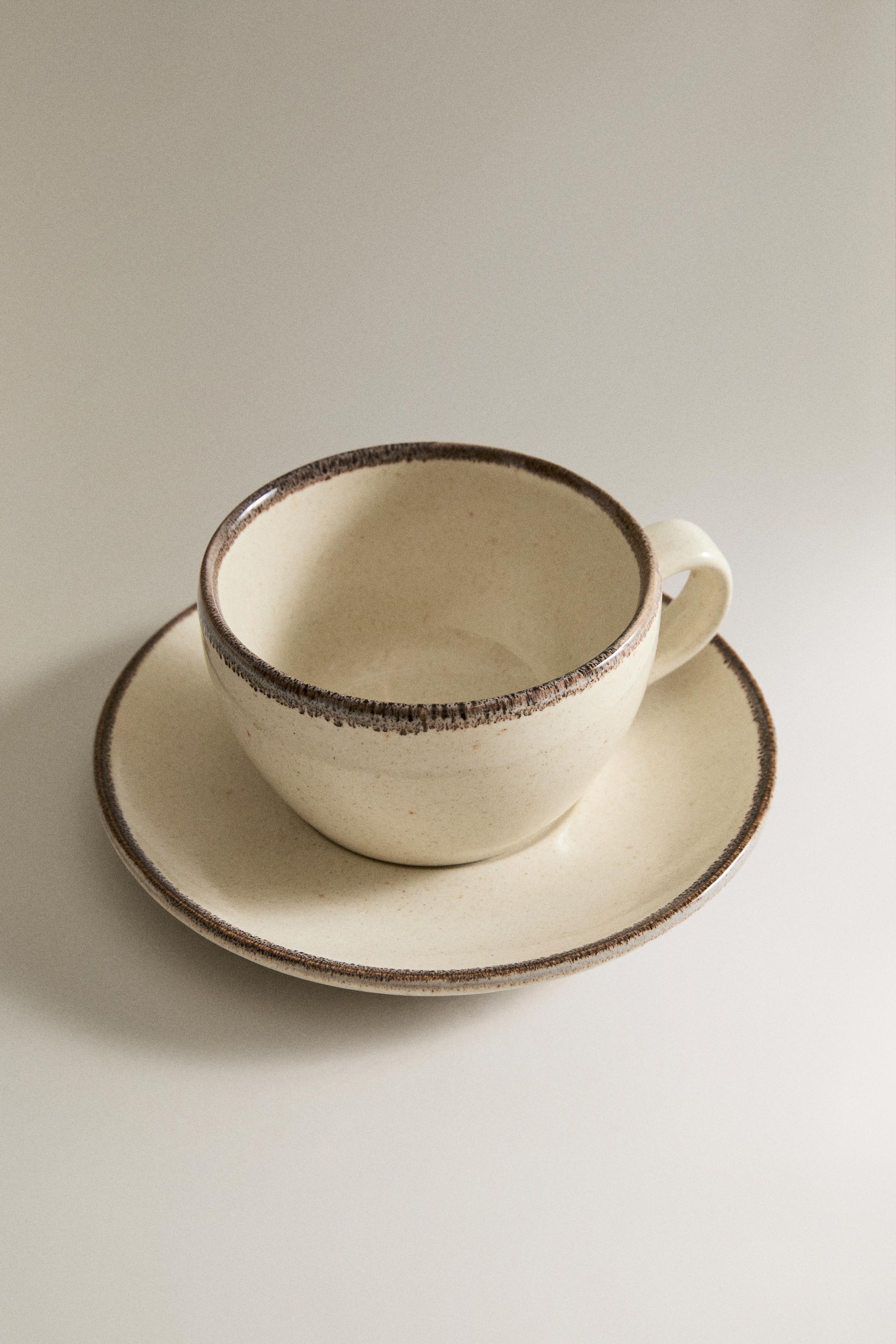 STONEWARE TEACUP AND SAUCER — Light ecru