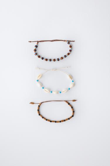 SET VAN DRIE KRALENARMBANDEN MET SCHELPJES - Bruin van Zara