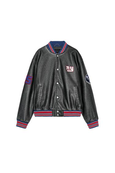 Front view of a black jacket with 'ny' text, number '5' on the sleeve, side patches, and side pockets.