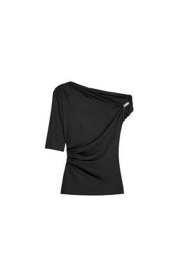 Front view of an asymmetric black blouse with a single off-the-shoulder design and pleated detailing.
