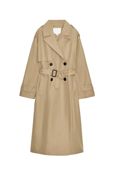 Front view of a light camel trench coat with a lapel collar, long sleeves, front pockets, and a belt. Double-breasted button fastening.