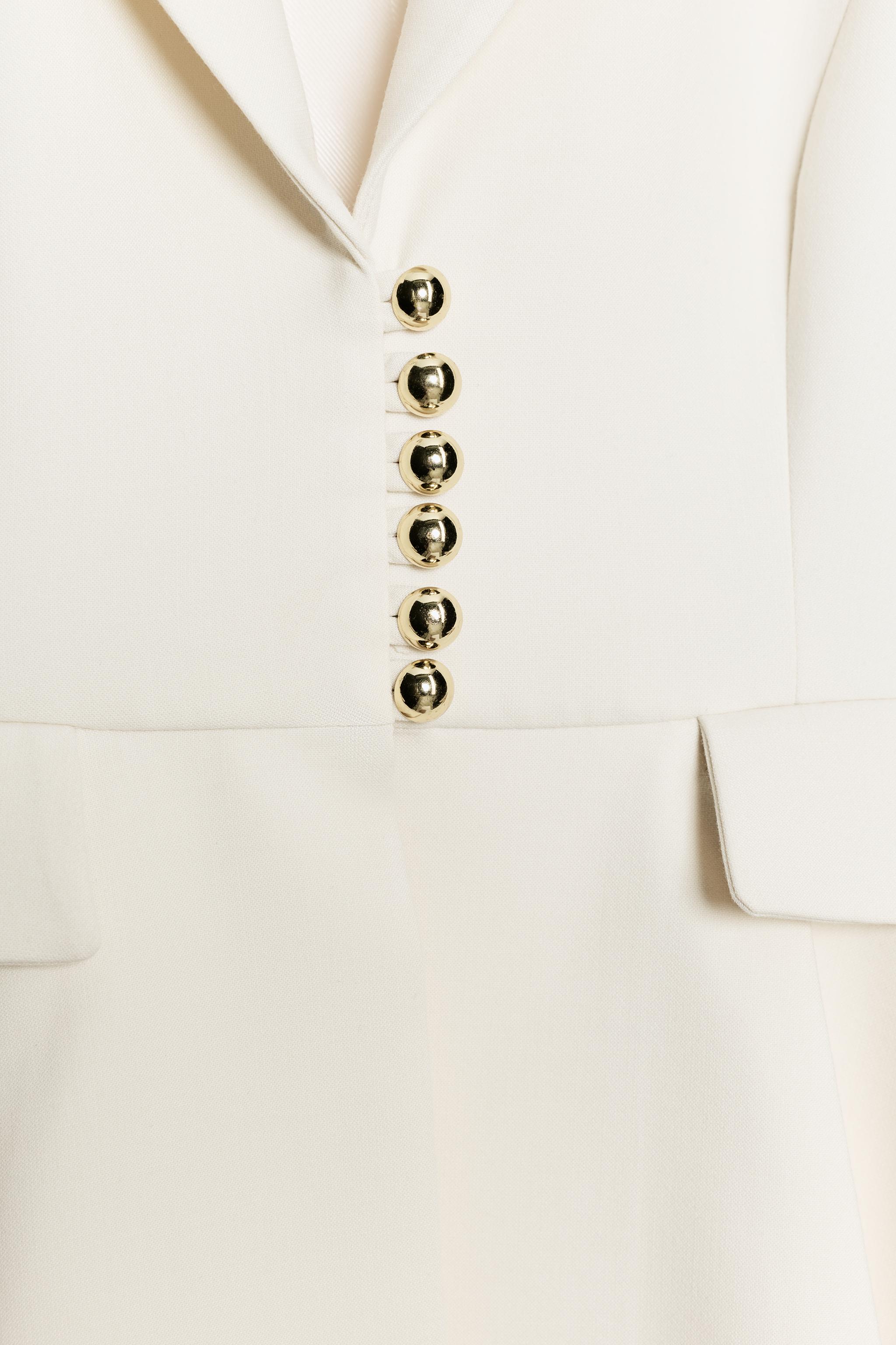 VESTE PÉPLUM À ÉPAULETTES
