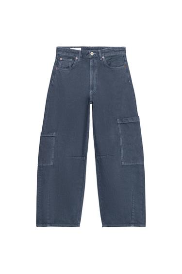 Front view of baggy ink blue jeans with patch pockets on legs and back, contrast stitching, zip and button.
