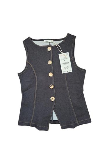 Dark blue denim sleeveless waistcoat with gold buttons and a hanging price tag showing US$ 4.5 and UK£ 2.99.