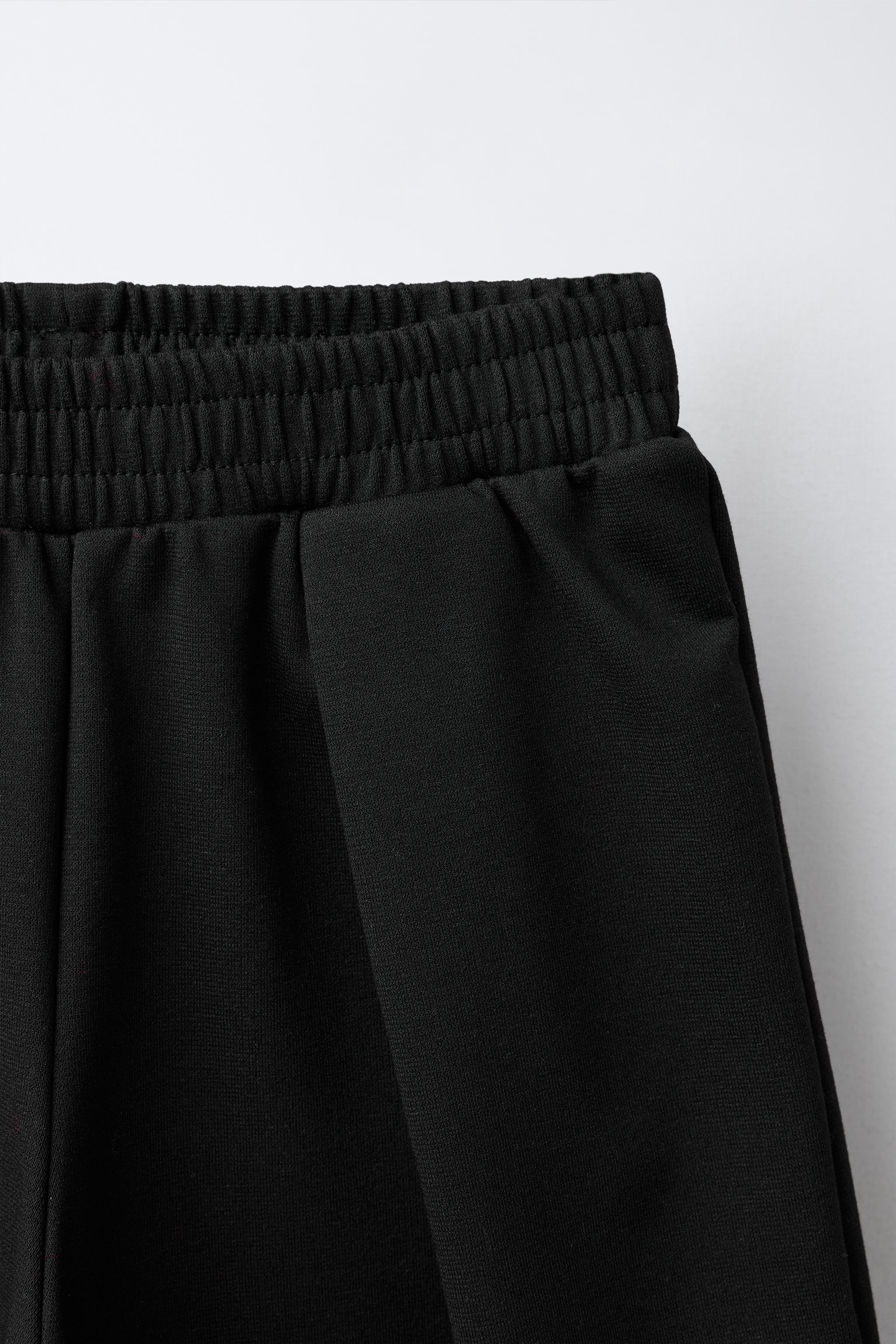 INTERLOCK PLEATED WIDE-LEG PANTS