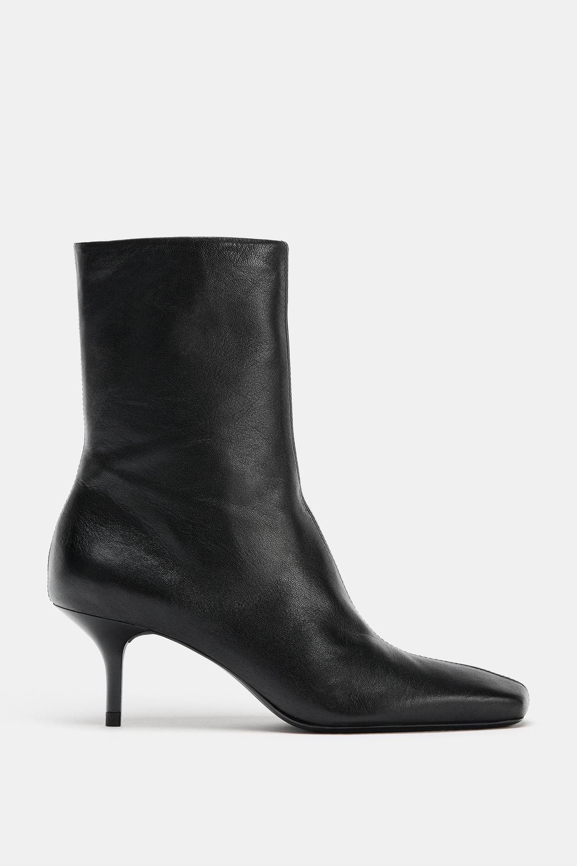 Side view of black stiletto heel ankle boot with a square toe.