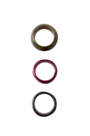 Front view of three rings in brown, red and black.