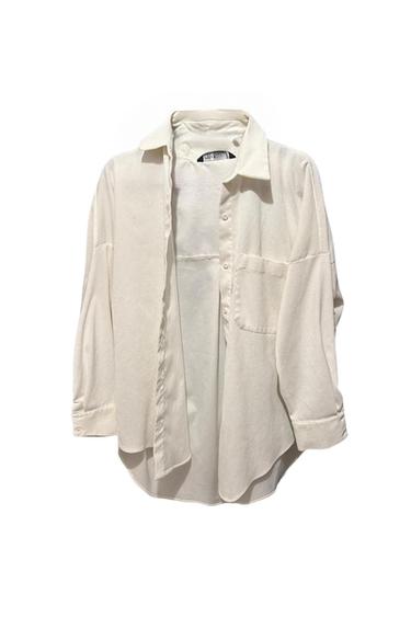 Front view of a white shirt with a classic collar, front button fastening and a chest pocket.