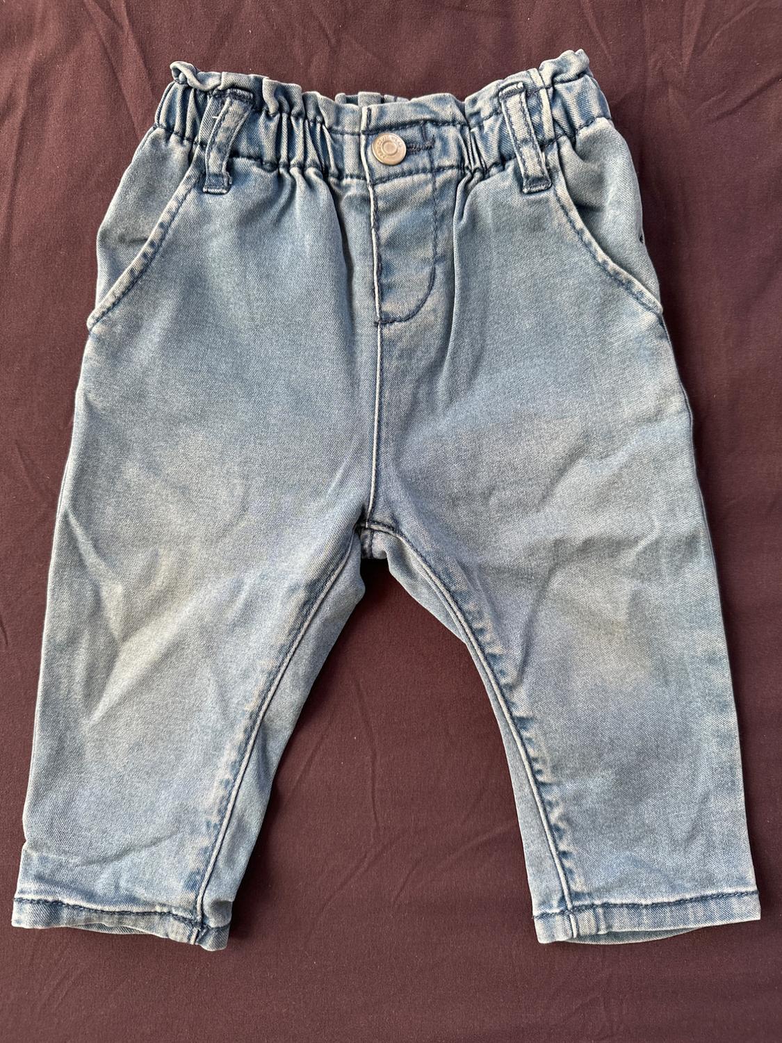 Front view of blue jeans with elastic waistband and side pockets.