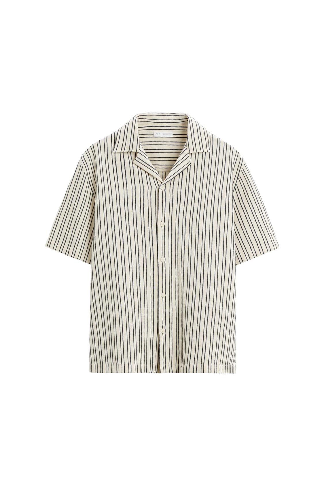 Short-sleeved shirt with a vertical stripe print on a light background. Design with a revere collar and button fastening on a white background.