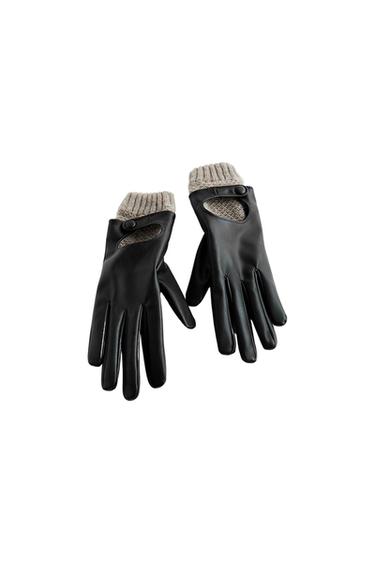 Front view of black gloves with grey knitted cuffs and a button detail on the wrist.