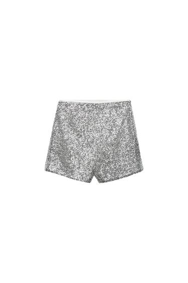 Silver shorts with shiny sequins on a white background.