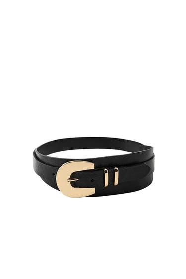Rolled-up black belt with a gold C-shaped buckle and two metal loops on a white background.