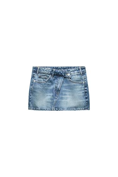 Blue denim mini skirt with a distressed effect, front pockets, and belt loops, on a white background.
