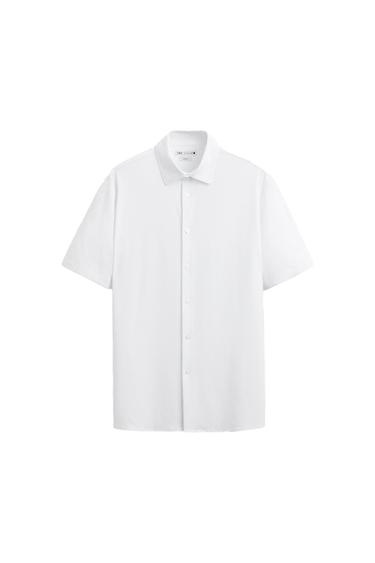 White short-sleeve button-down shirt on a white background. Text on the inner label: ZARA SLIM FIT.