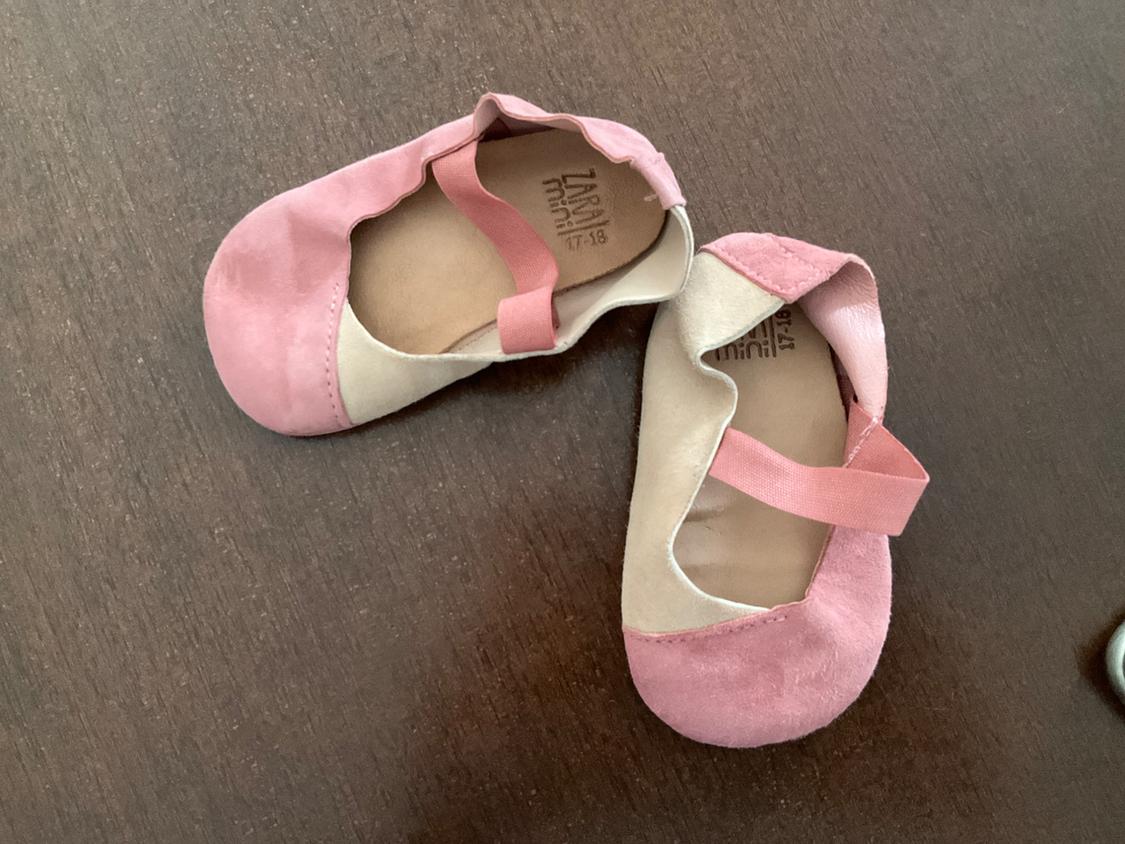 Front view of pink and beige baby shoes with elastic strap.