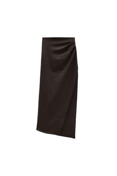 High-waisted midi skirt. Draped fabric detail at waist. Side slit at hem. Back hidden in-seam zip closure.