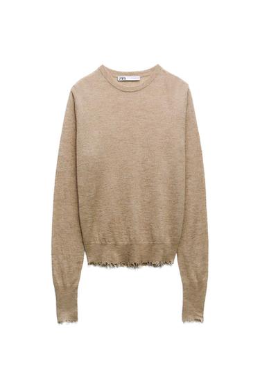 Beige knit jersey with a crew neck and long sleeves. Features frayed details on the hem and cuffs. ZARA text on the label.