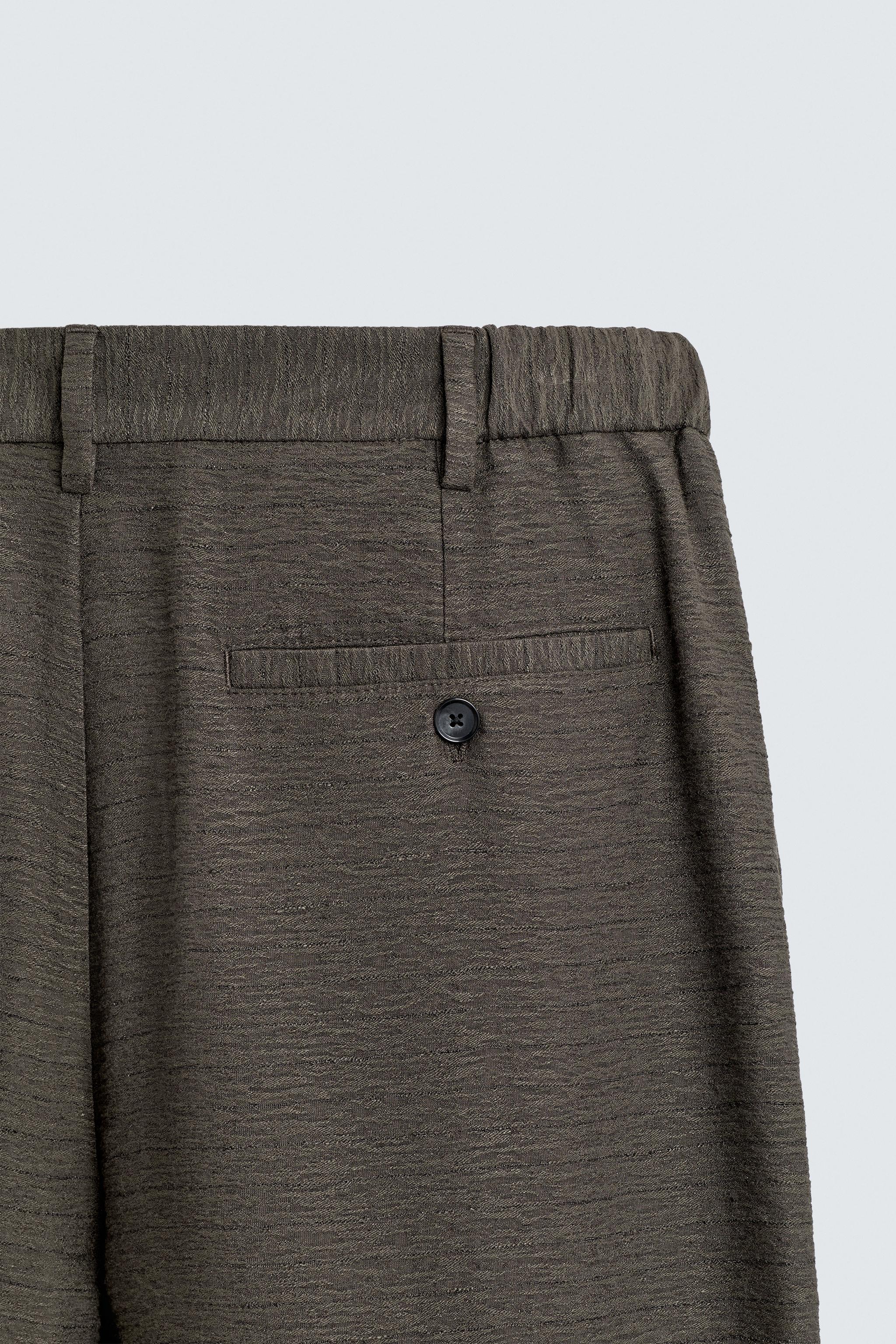 FLOWY TEXTURED PLEATED PANTS