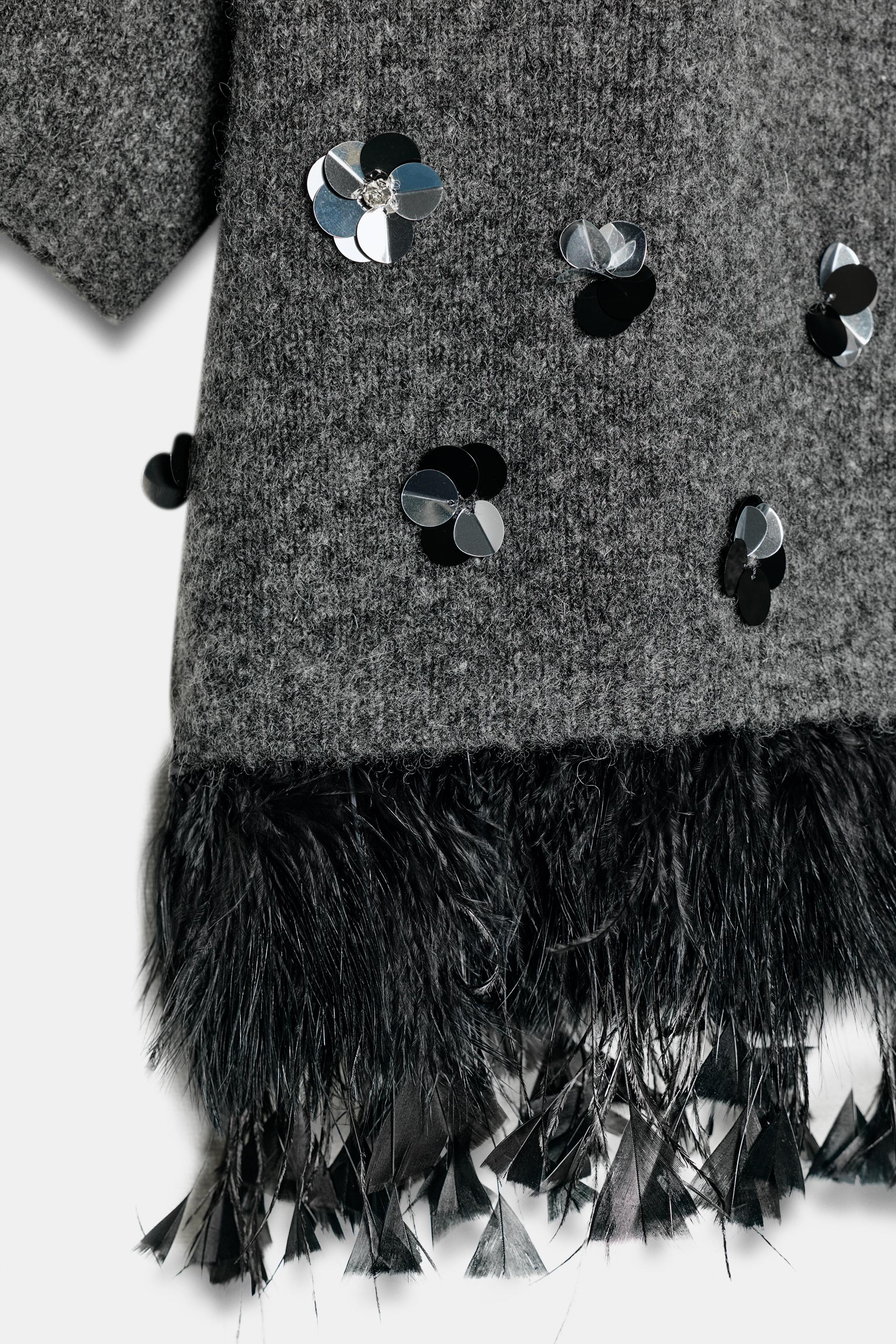WOOL SWEATER WITH SEQUINS AND FEATHERS