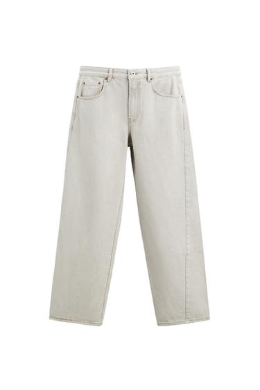 Front view of beige trousers with front pockets and visible button.