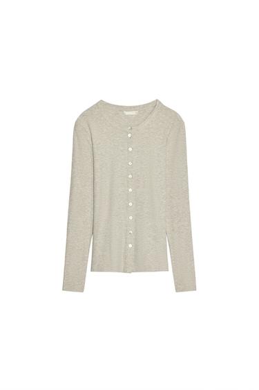 Front view of a light grey cardigan with white buttons and long sleeves.