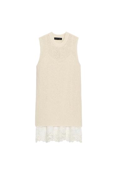 Front view of a raw, sleeveless dress with a round neck and lace detailing on the hem.