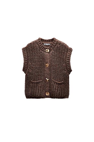 Front view of a brown waistcoat with gold buttons and front pockets.